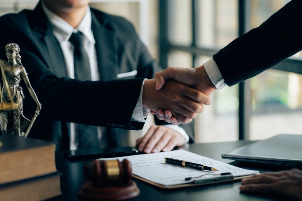 Attorney shaking hands with a client after a successful real estate closing